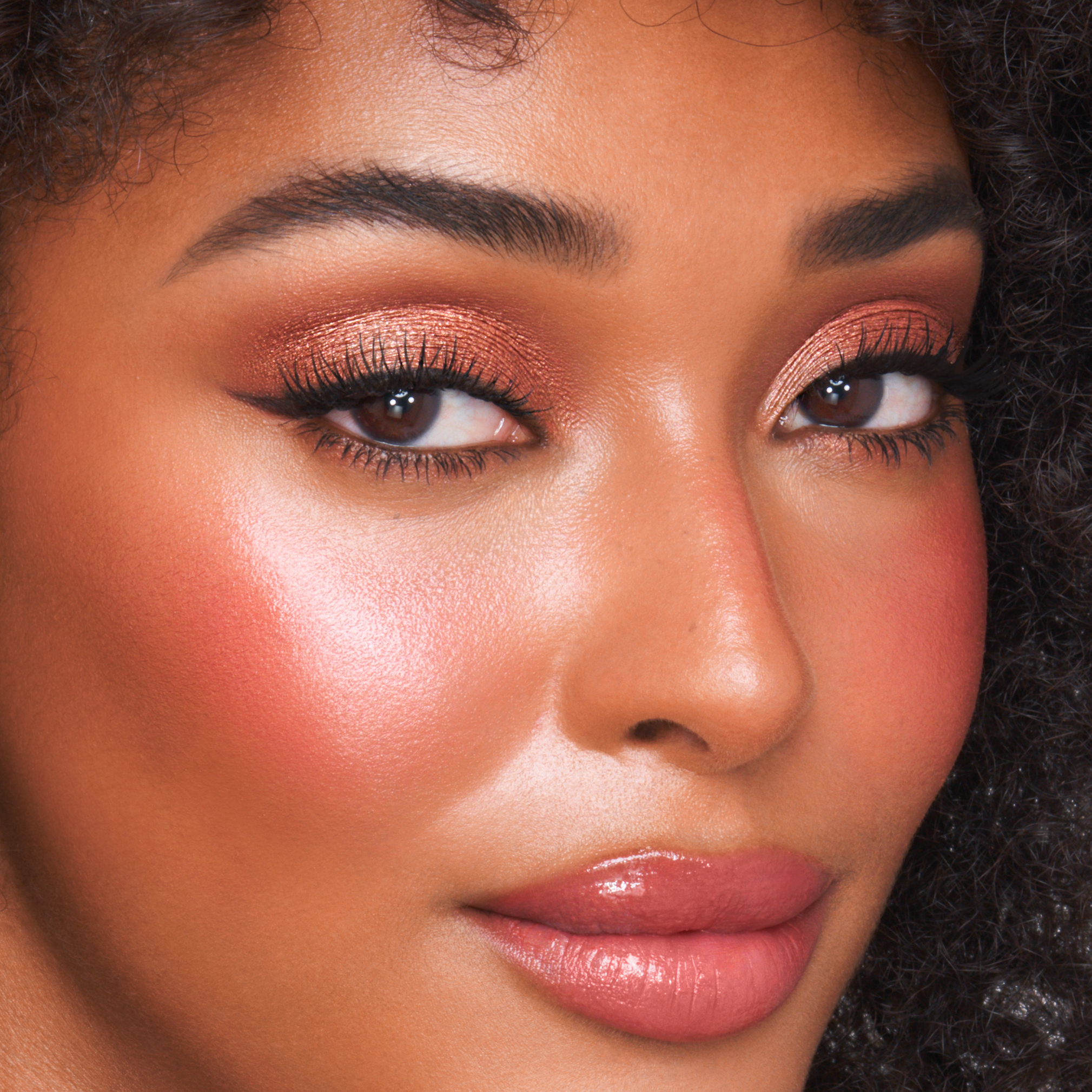 Model wears a beach wedding makeup look using Beach Stick cream blush
