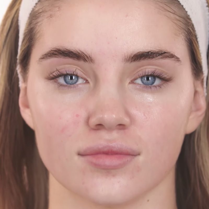 A fair-tone model with blue eyes wearing no makeup, with glowy, glass skin. 