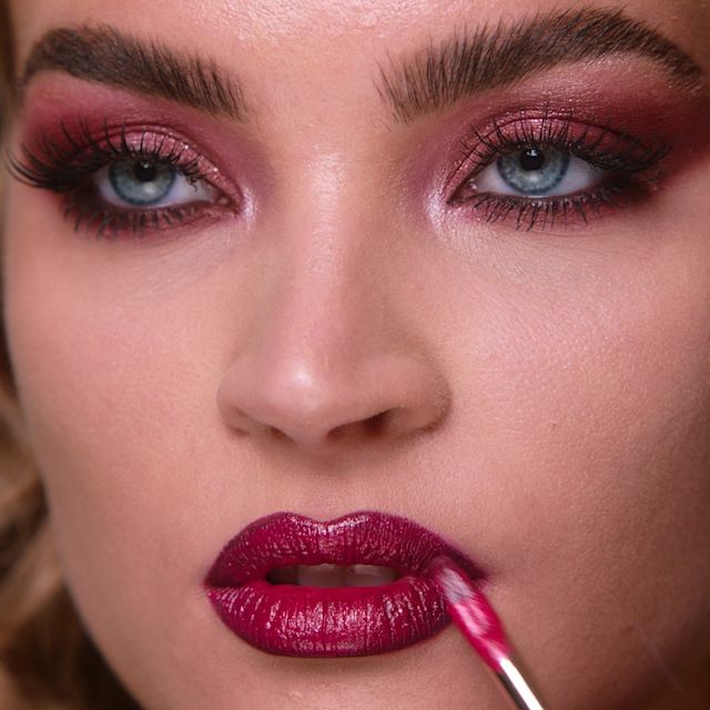 Step 10 in Sofia Tilbury's 80s Makeup Look tutorial: apply bold lipstick