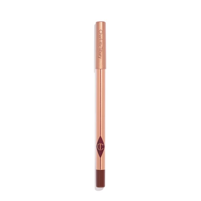 Lip Cheat in Pillow Talk Intense with pink packaging A dark red-brown lip liner pencil with a golden-coloured body with nude-pink box packaging.
