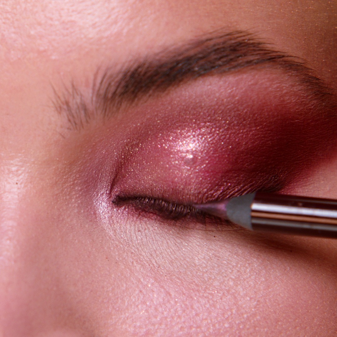 Step 7 in Sofia Tilbury's 80s Makeup Look tutorial: apply colourful eyeliner