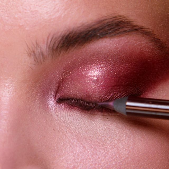 Step 7 in Sofia Tilbury's 80s Makeup Look tutorial: apply colourful eyeliner