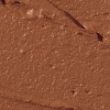 Swatch of a hydrating cream bronzer in a dark-brown shade.