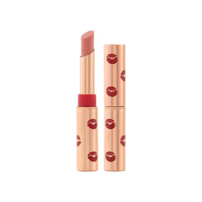 Limitless Lucky Lips in Velvet Nude with and without lid Two lipsticks, with and without lid, in a soft taupe shade with gold-coloured tubes with red-coloured kiss print all over the tubes.