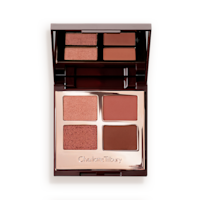 An open quad eyeshadow palette with metallic and matte shades of pearlescent rose gold, dusky rose, berry brown and rose-bud pink.