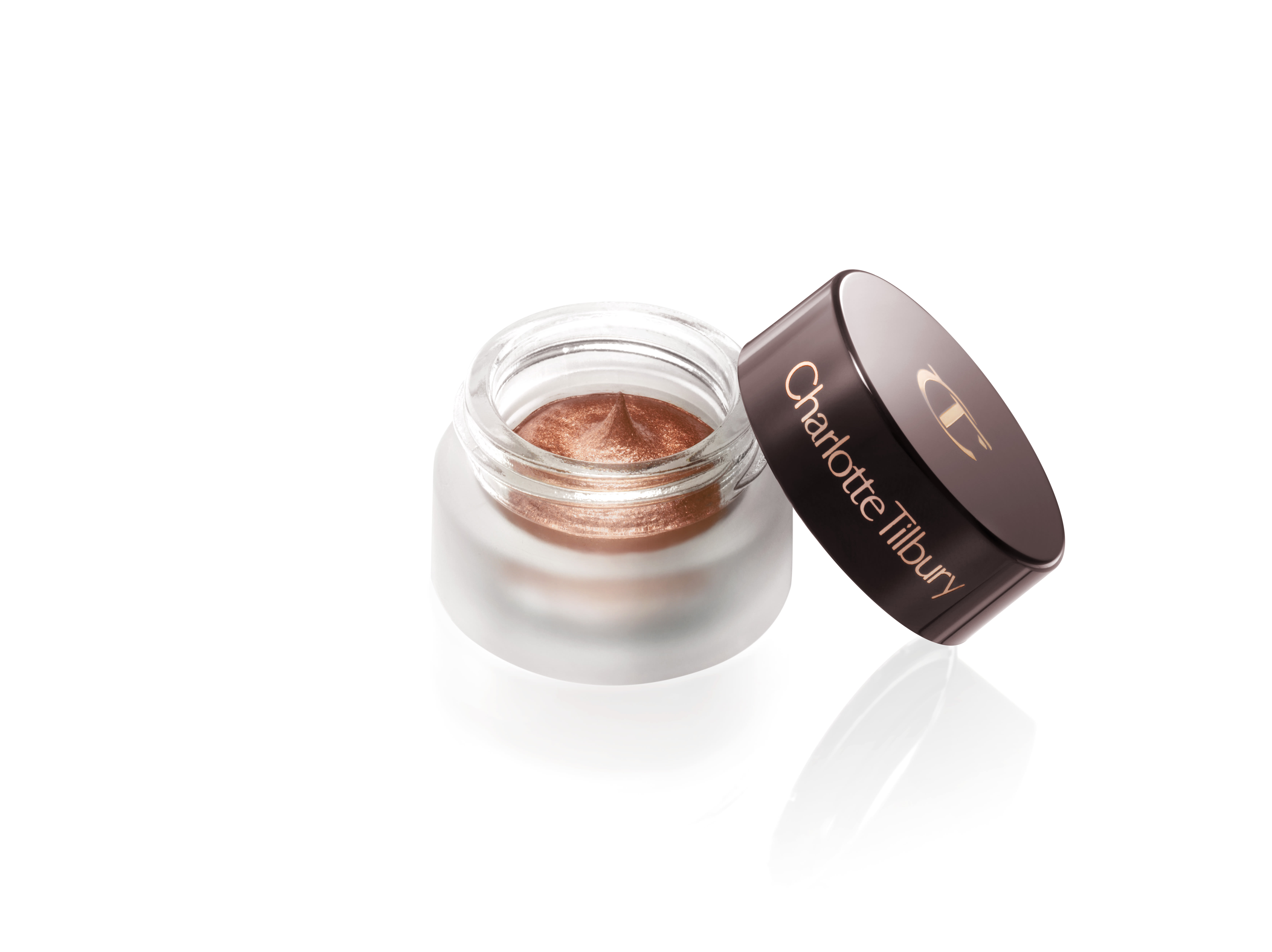 An open pot of cream eyeshadow in a shimmery, russet rose colour with its lid next to it.