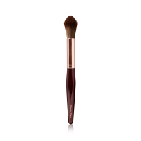 A powder brush with soft bristles and the handle in a dark crimson and rose-gold colour scheme. 