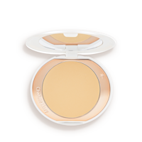 An open, setting powder compact with a mirrored-lid and white and gold-coloured packaging.