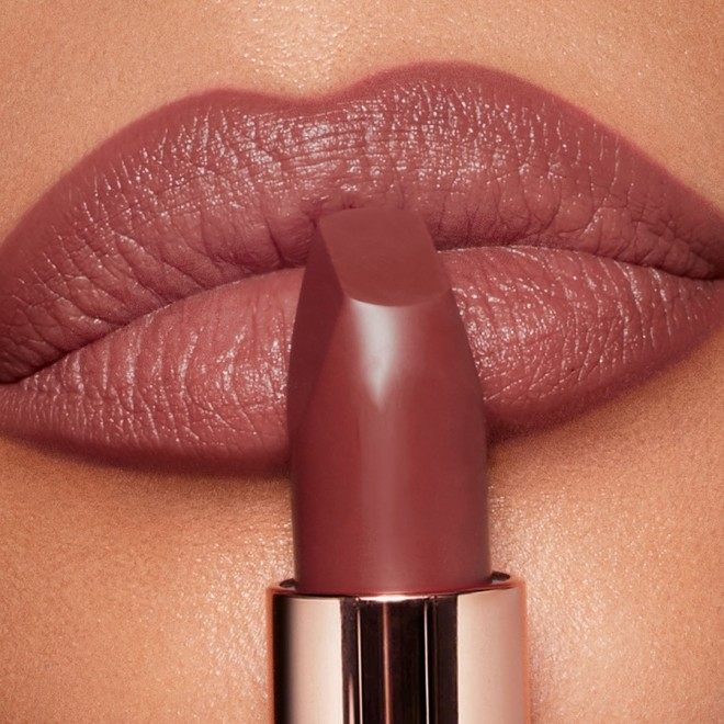 Brunette model wearing Pillow Talk Medium Matte Revolution lipstick