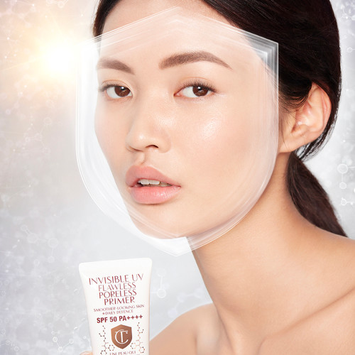 Fair-tone brunette model wearing a smoothing primer with a satin-finish with an illusion of a shield over her face to depict protection from UV rays.