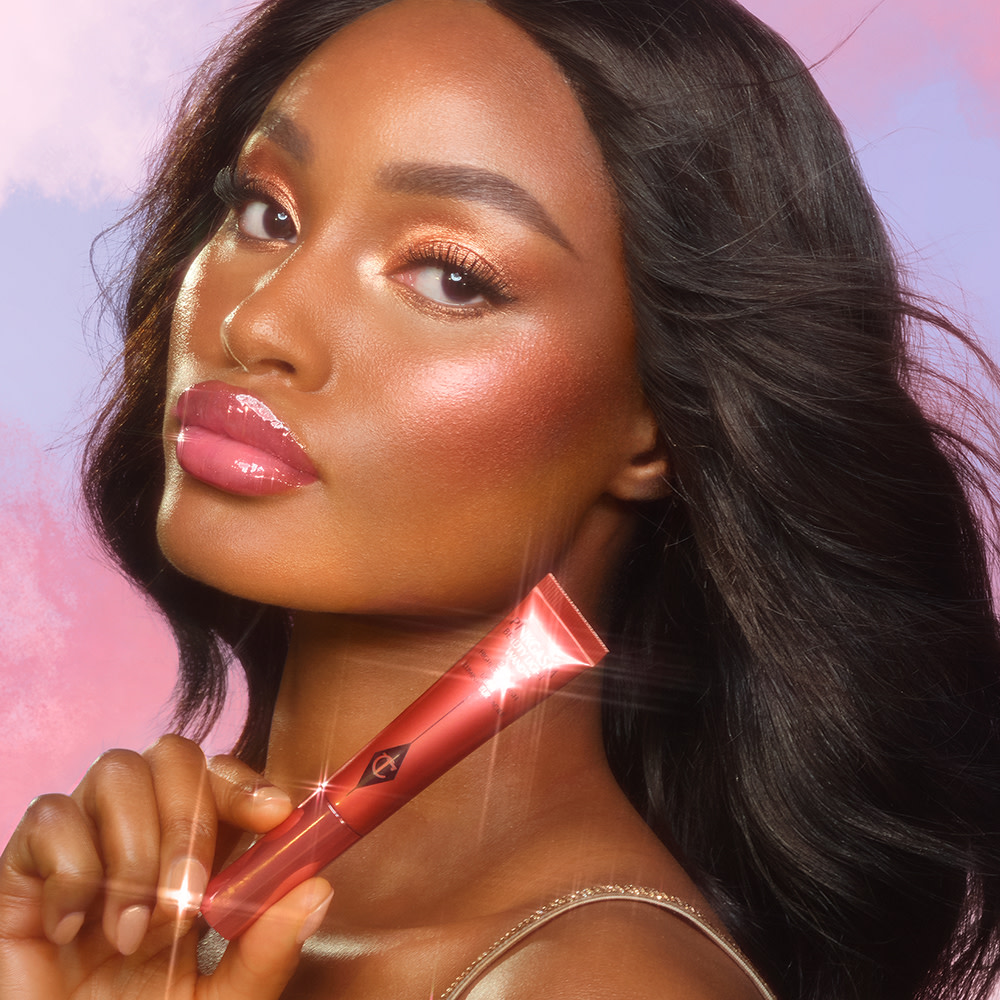 Blessing wearing a sunset makeup look with Charlotte's Beauty Light Wand in Pinkgasm Sunset
