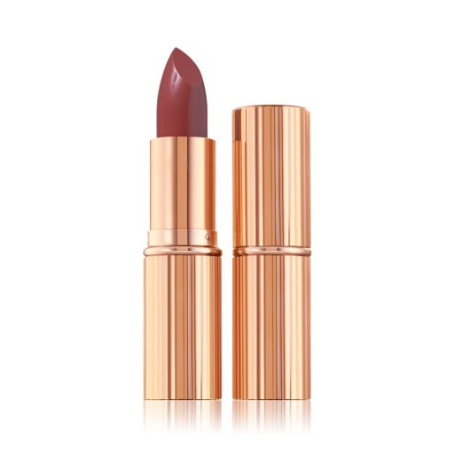an open satin-finish lipstick in a reddish, rose-pink shade in a standard-sized, metallic, golden tube next to an unopened lipstick encased in a metallic, golden tube. 