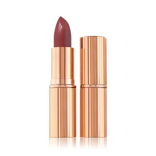 an open satin-finish lipstick in a reddish, rose-pink shade in a standard-sized, metallic, golden tube next to an unopened lipstick encased in a metallic, golden tube. 