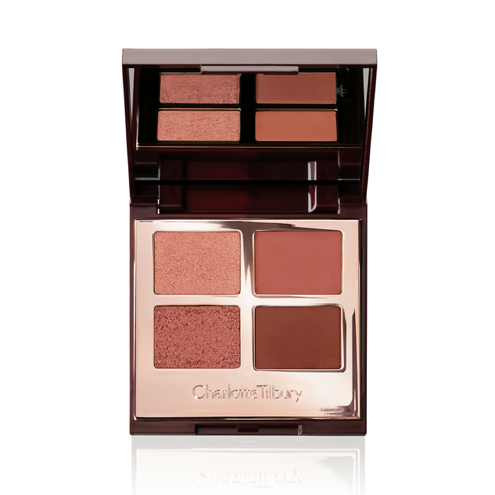 An open quad eyeshadow palette with metallic and matte shades of pearlescent rose gold, dusky rose, berry brown and rose-bud pink.