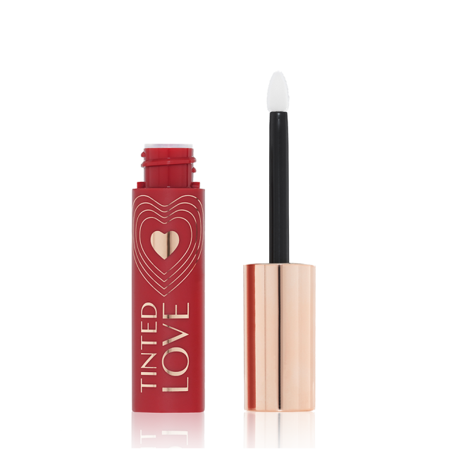 An open lip and cheek tint with a gold-coloured lid in a vibrant-red-coloured tube. 