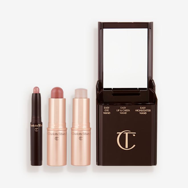 Quick & Easy Instant 5 Minute Date Night Look Kit products displayed An open shadow stick in a shimmery pink shade, a lip and cheek blush stick in a soft pink shade, and highlighter stick in an opal shade.