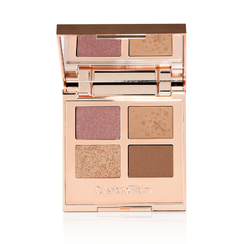 An open, mirrored-lid quad eyeshadow palette with soft earthy-tones in shades of pink, brown, and gold.