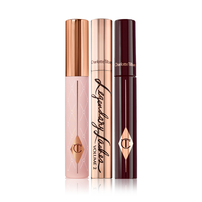 Three mascaras, one in a light pink tube with a gold-coloured lid, another in a gold-coloured tube with matching lid, and the last in dark crimson packaging.