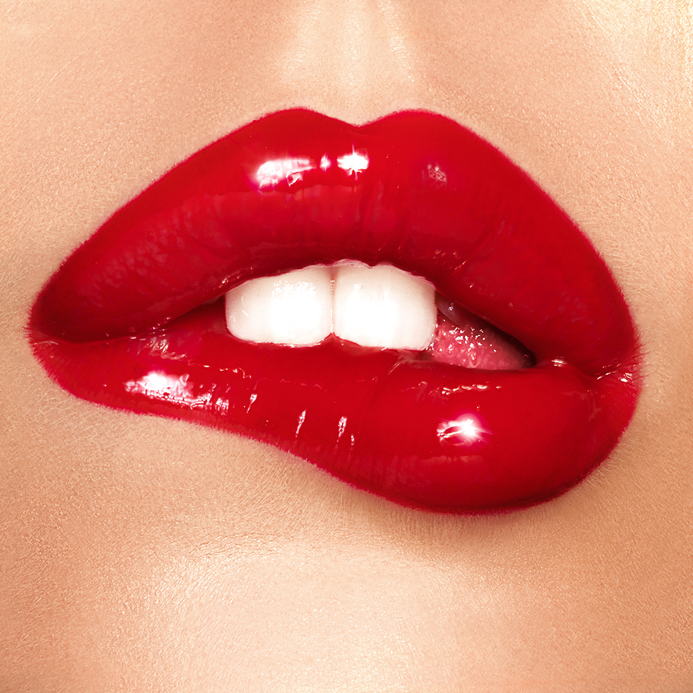 Model wearing a glossy red lip using Lip Lustre in Red Vixen