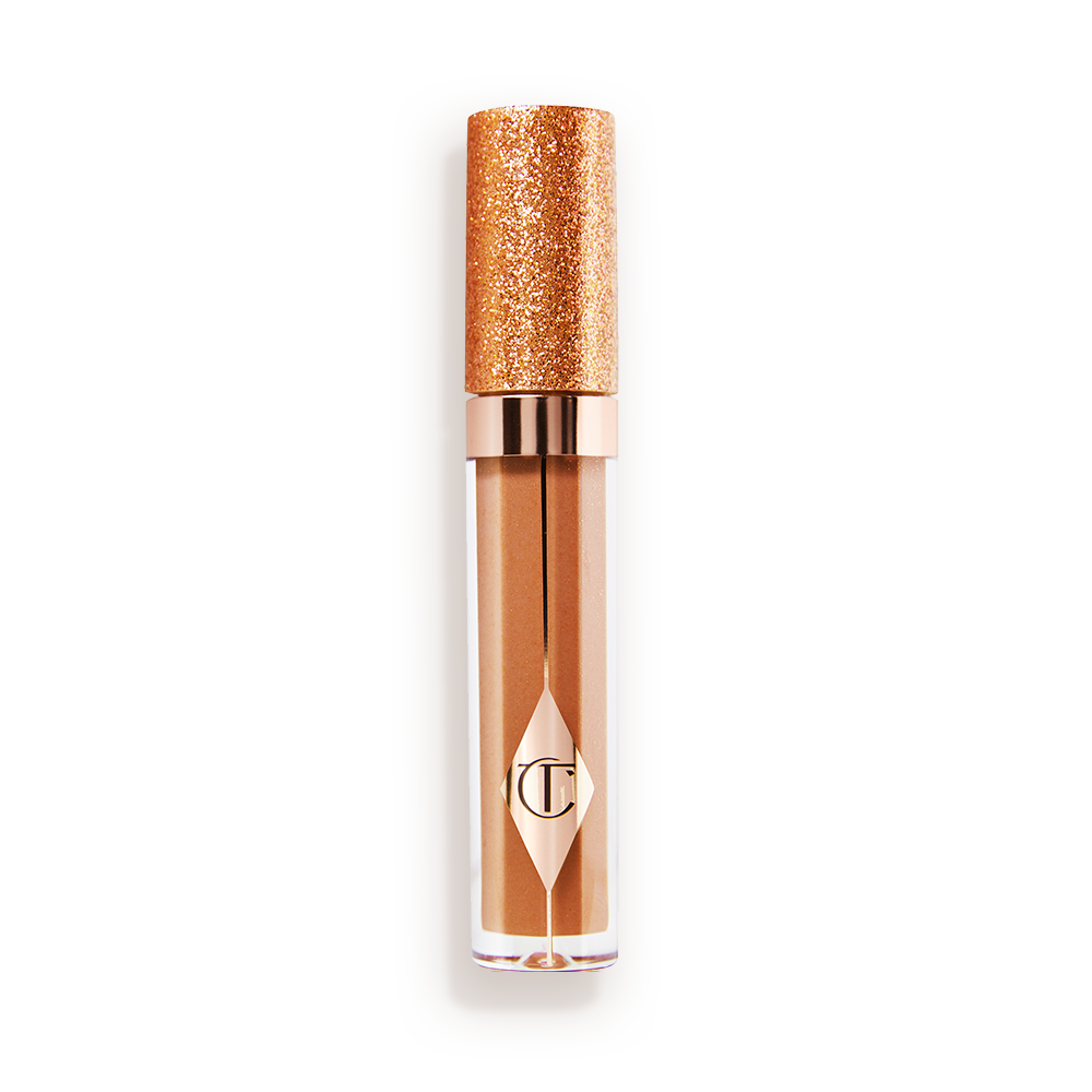A closed, shimmery, gold-coloured lip gloss with rose gold sparkles and a glittery lid.