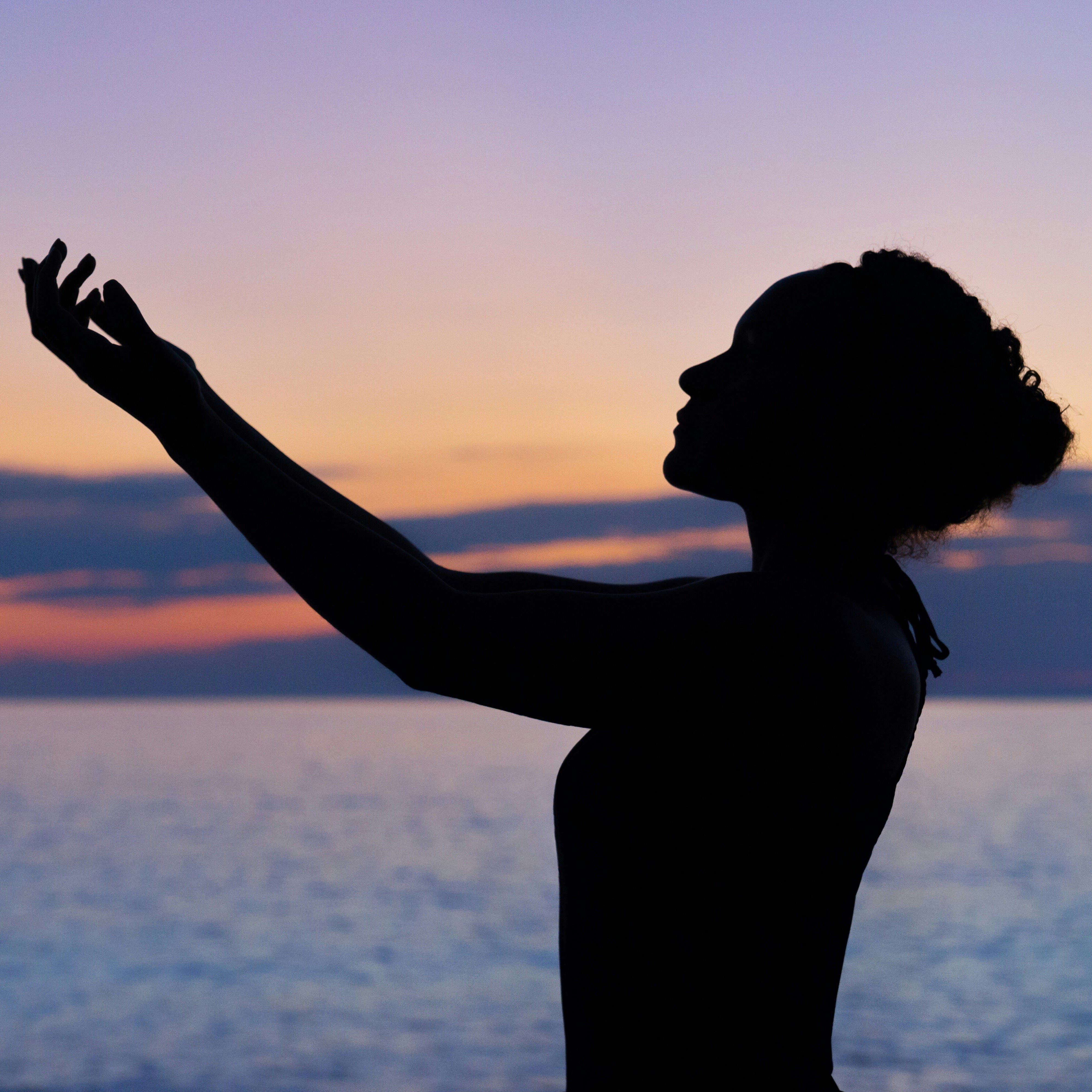 Silhouette of a person on the beach at sunset