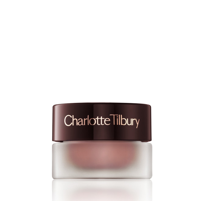 Cream eyeshadow in a glass pot in a nude pink shade with fine shimmer with a dark brown-coloured lid.