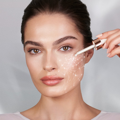 A fair-tone brunette model applying a pearlescent serum with a dropper on her face.  