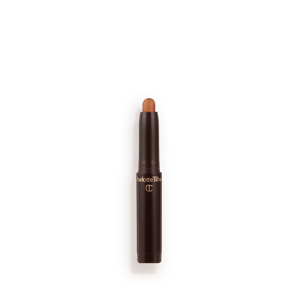 An open, cream eyeshadow wand in a golden bronze shimmer shade.