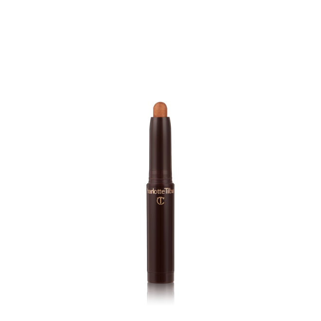 An open, cream eyeshadow wand in a golden bronze shimmer shade.