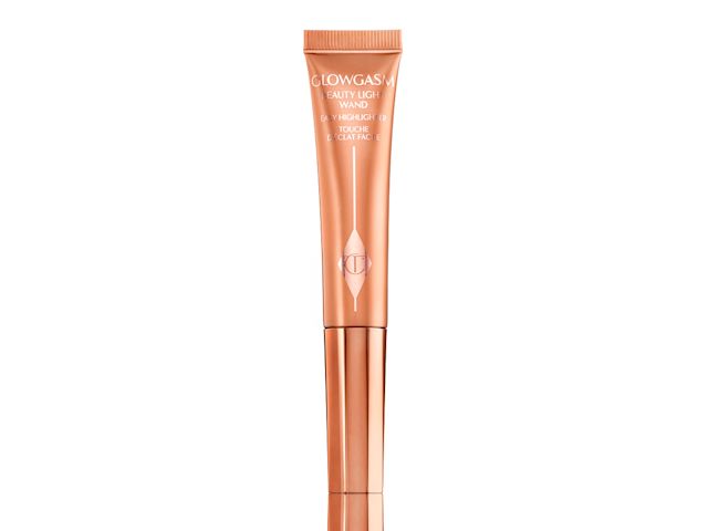 A liquid highlighter-blush wand in shiny, copper-coloured packaging. 