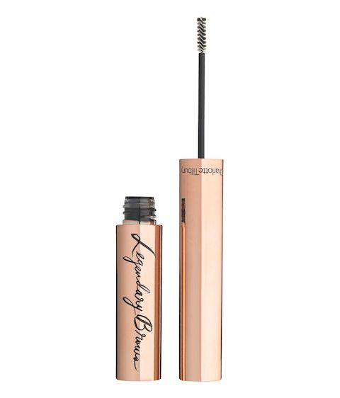 An open, brow gel in a golden-coloured tube with its thin, spoolie applicator next to it. 