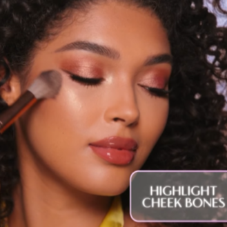 Model wearing the highlighter shade in Glowgasm Face Palette