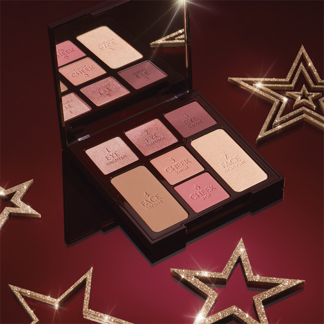 An open, face palette with a mirrored-lid with three rose gold, dusky pink, and plum-coloured eyeshadows, two blushes in soft peach and medium-pink, light brown bronzer, and soft, gold-coloured highlighter.