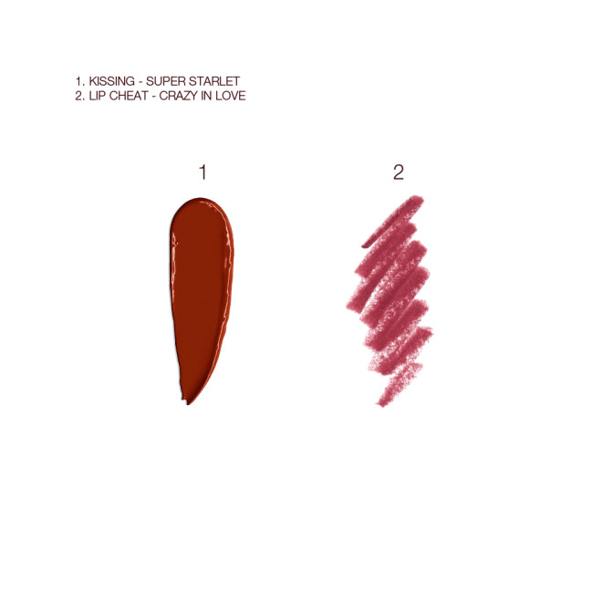 Swatches of a matte lipstick and lip liner pencil in a deep winter berry red shade.