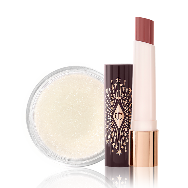 An open lipstick balm in a berry-pink shade with a white-coloured lip scrub in an open glass jar. 