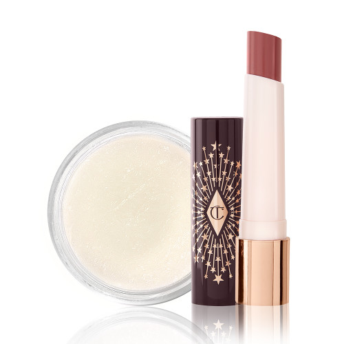 An open lipstick balm in a berry-pink shade with a white-coloured lip scrub in an open glass jar. 