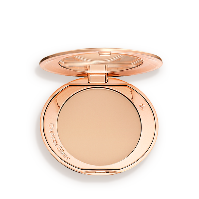 Airbrush Flawless Finish in Medium open An open, pressed powder compact in a light beige shade.