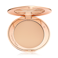 An open, pressed powder compact in a light beige shade. 