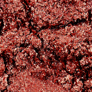 Swatch of an iridescent rustic red eyeshadow with very fine shimmer. 