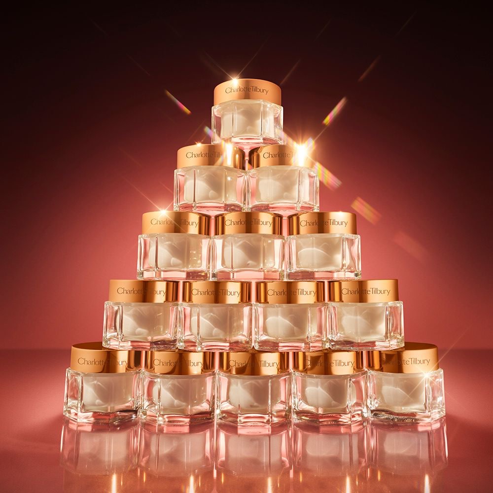 Pyramid stack of 15 jars of Charlotte's Magic Cream moisturiser with sparkles