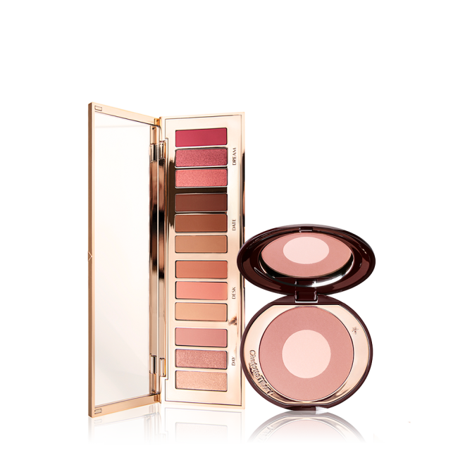 An open, mirrored-lid eyeshadow palette in pink, brown, peach, and golden shades with a two-tone,  mirrored-lid powder blush in pearlescent pink. 