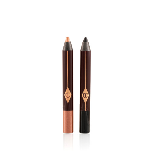 Two chubby eyeshadow sticks, in coppery-brown and black colours, with their lids removed. 
