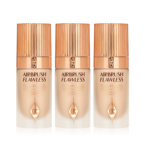 Three foundations in fair shades in frosted glass bottles with gold-coloured lids. 