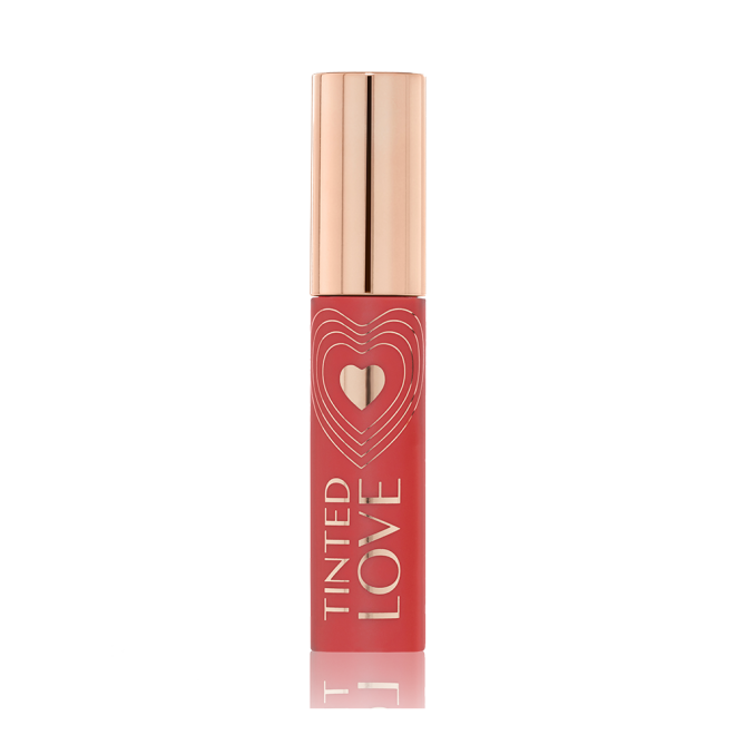 A closed lip and cheek tint with a gold-coloured lid in a warm peachy-brown-coloured tube.