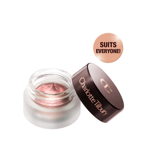 Cream eyeshadow in an open glass pot in a nude pink shade with fine shimmer, with the lid placed next to it.