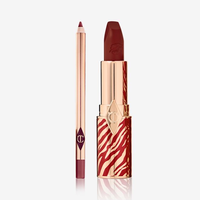 Lunar New Year Lip Kit in K-Romance open An open lip liner pencil in a maroon shade with an open lipstick in a muted berry-rose shade, in a gold-coloured tube with red tiger stripes all over the bottom half of the tube in celebration of the Lunar New Year.