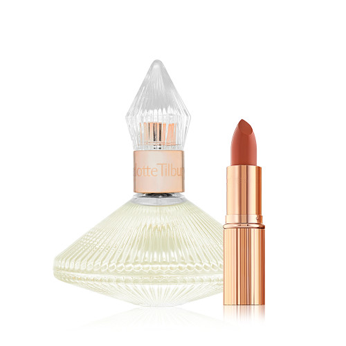 A 100 ml perfume in a glass bottle with a glass lid with an open lipstick in a peachy-red shade in a golden-coloured tube. 