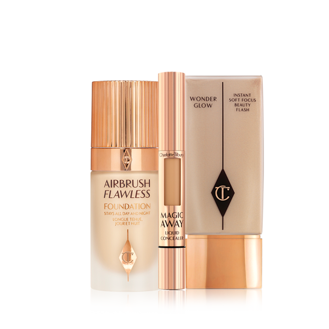 Creamy liquid concealer in a sleek gold-coloured tube with a soft sponge end for application, foundation in a frosted glass bottle with a gold-coloured lid, and foundation in a rectangular bottle with a gold-coloured lid.