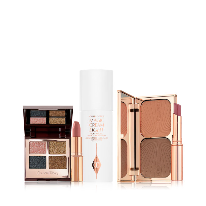 Open, quad eyeshadow palette with a mirrored-lid with shimmery shades of teal, rose gold, bronze, and dark brown, nude pink matte lipstick, pearly-white face cream in a white bottle, duo contour palette, and nude pink sheer lipstick in a gold-coloured tube.