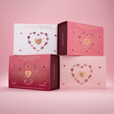 Banner with four, makeup sleeves in shades of pink and white with hearts printed on them and the CT logo printed in gold colour in the middle.
